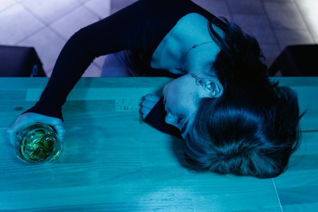 a woman passing out in a bar counter