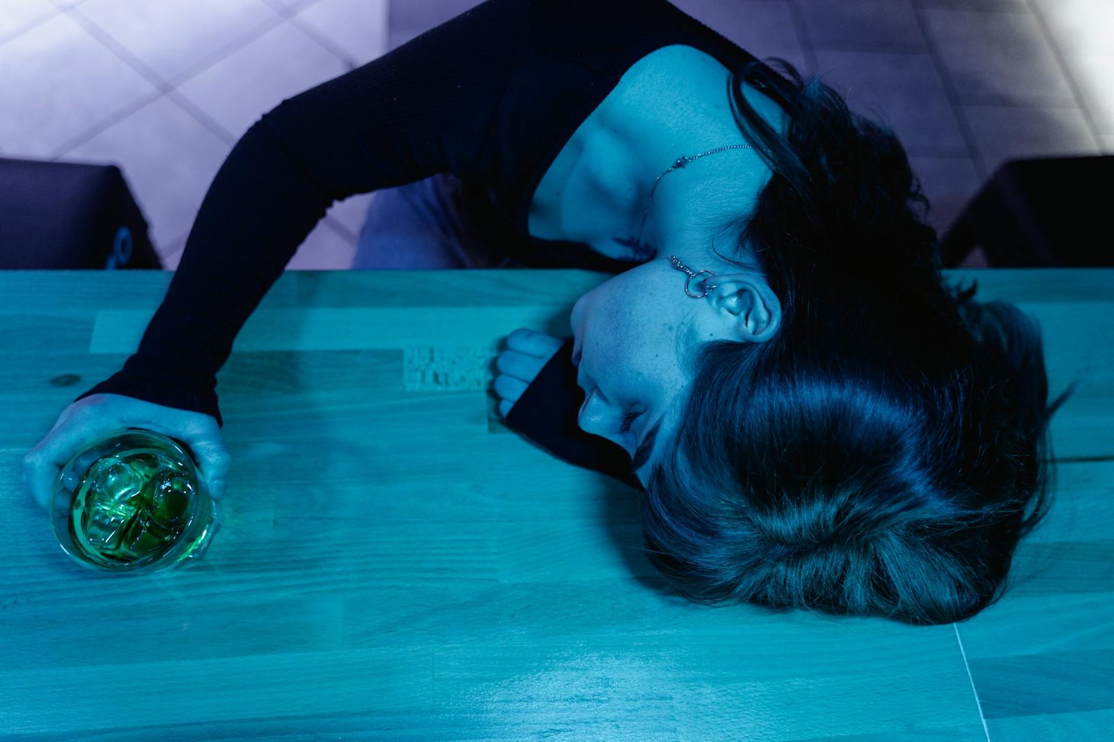 How Alcohol Affects Your Sleep: The Nightcap Dilemma 1 a woman passing out in a bar counter