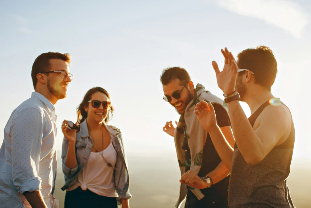"How to Make Friends as an Adult?" three men and one woman laughing during daytime,