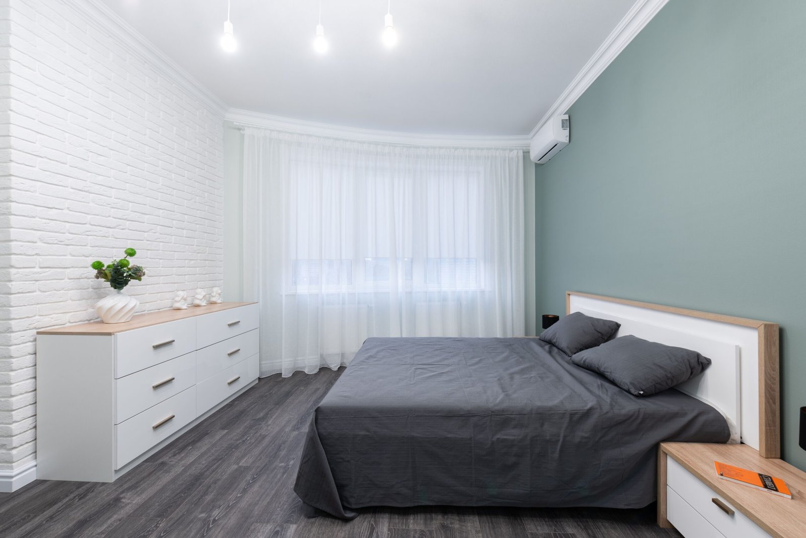 Bedroom with bed and dresser showing usable floor space between furniture