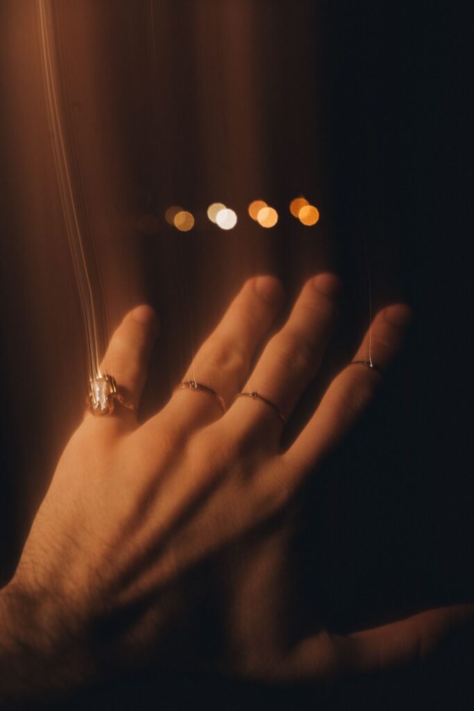 Close-up of a hand wearing several rings